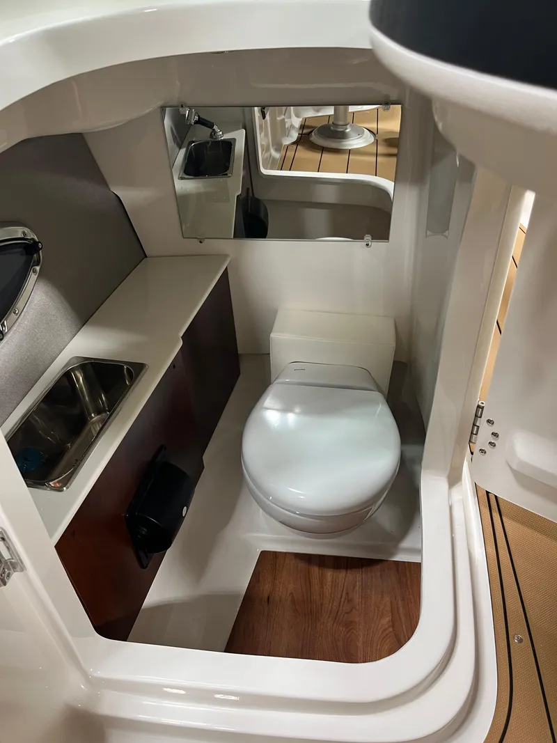 Slide: The Image of 2025 Chaparral 267 SSX boat interior with tan leather seating and modern dashboard. - 11