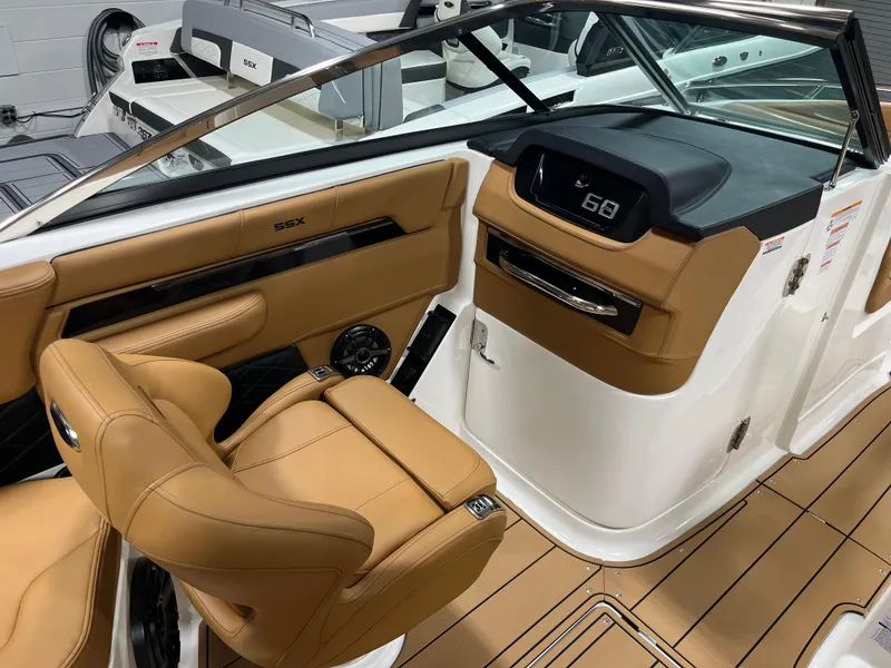 Slide: The Image of 2025 Chaparral 267 SSX interior detail with wireless charging pad and USB port. - 13