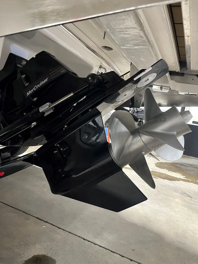 Slide: The Image of 2025 Chaparral 267 SSX boat interior with tan seating and round table. - 14