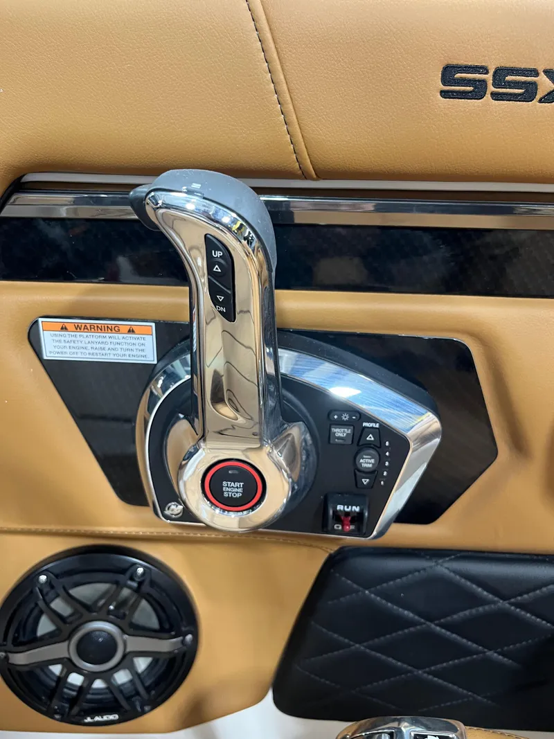 Slide: The Image of 2025 Chaparral 267 SSX boat interior with tan leather seating and sleek design. - 15