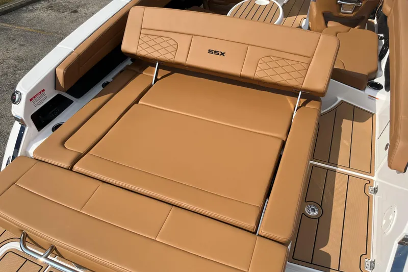Slide: The Image of 2025 Chaparral 267 SSX boat with tan leather seating and sleek deck design. - 17