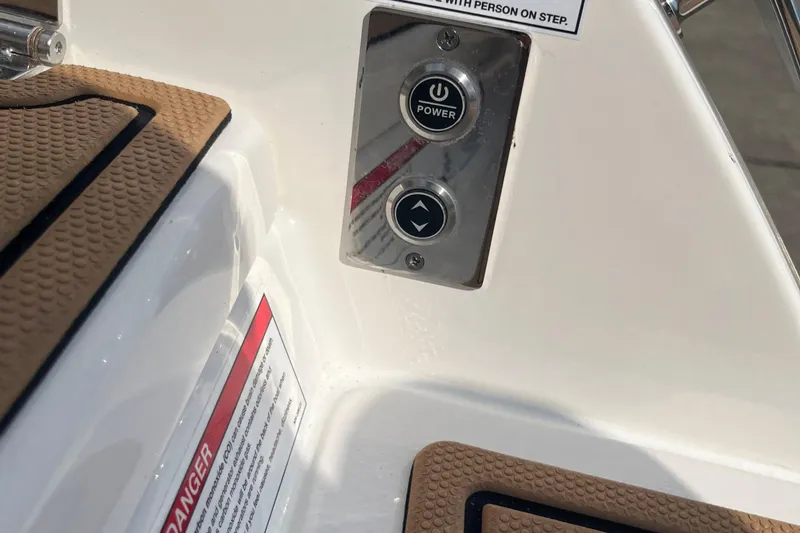 Slide: The Image of Control panel on 2025 Chaparral 267 SSX boat with power and directional buttons. - 23