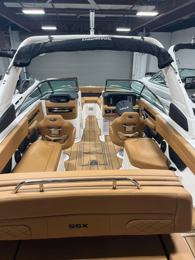 Slide: The Image of 2025 Chaparral 267 SSX boat bow with white textured deck and tan seating. - 4