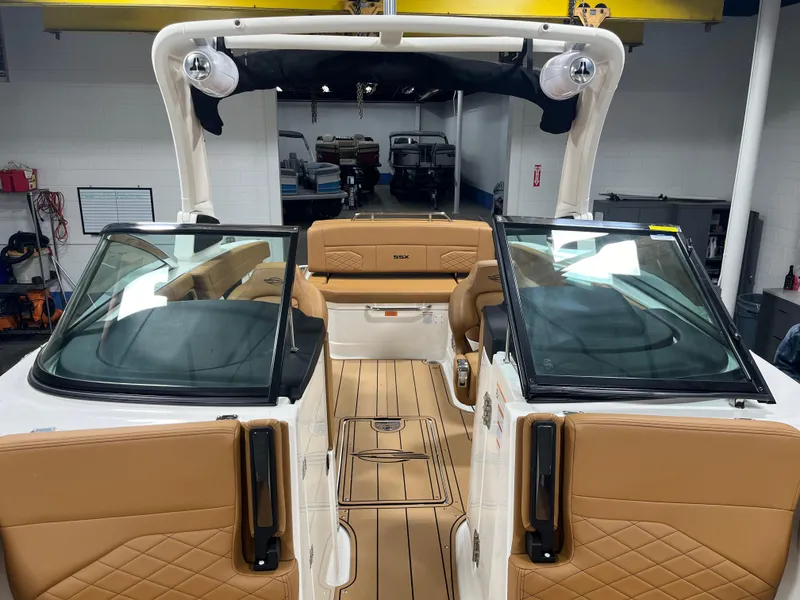 Slide: The Image of Luxurious interior of 2025 Chaparral 267 SSX boat with tan leather seating and sleek design. - 7