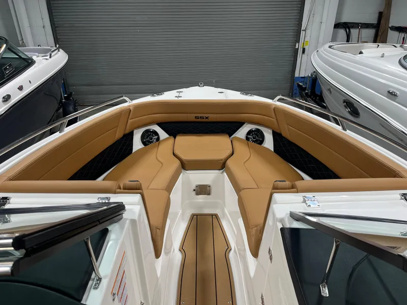Slide: The Image of 2025 Chaparral 267 SSX boat interior with tan leather seating and modern dashboard. - 8
