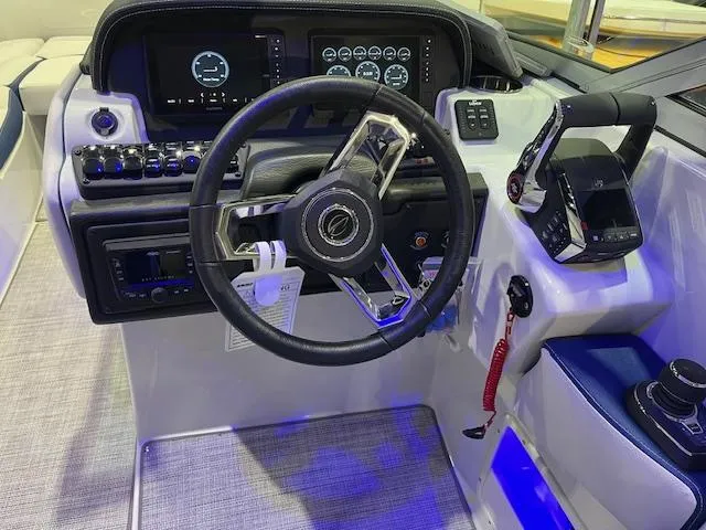 Slide: The Image of 2025 Crownline Eclipse E305 boat dashboard with modern steering wheel and controls. - 3