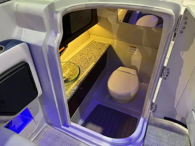 Slide: The Image of 2025 Crownline Eclipse E305 boat interior bathroom with modern amenities and sleek design. - 4