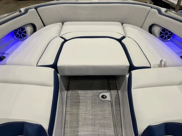 Slide: The Image of 2025 Crownline Eclipse E305 boat interior with white and blue seating, illuminated speakers. - 5