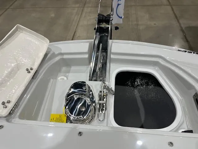Slide: The Image of 2025 Crownline Eclipse E305 boat deck with anchor storage and hatch. - 6