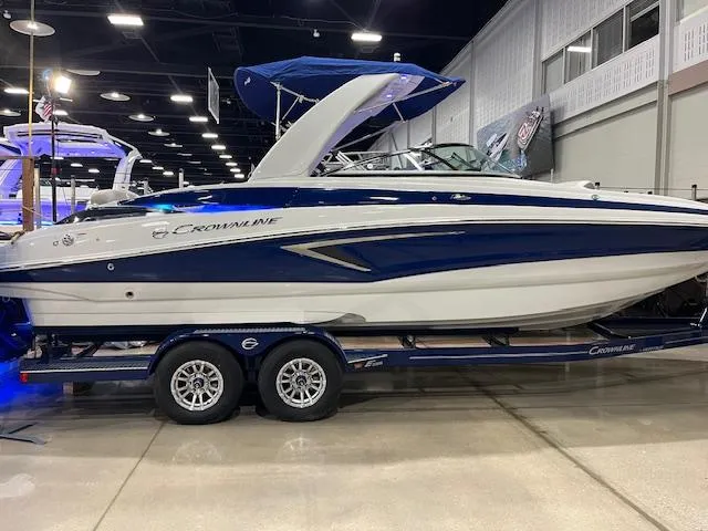 Slide: The Image of 2025 Crownline Eclipse E285 boat on display in a showroom. - 0