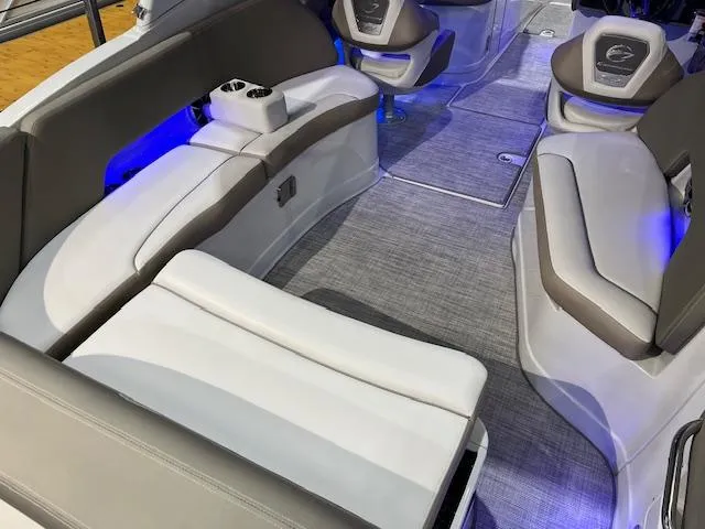 Slide: The Image of Interior of 2025 Crownline Eclipse E285 boat with modern seating and blue LED lighting. - 1