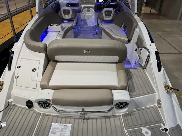Slide: The Image of 2025 Crownline Eclipse E285 boat interior with beige seating and modern design. - 2