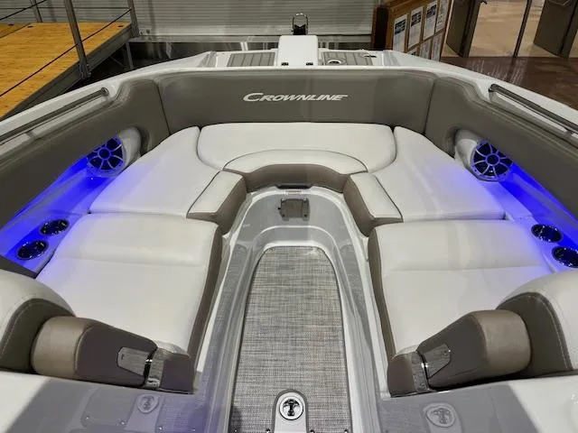 Slide: The Image of 2025 Crownline Eclipse E285 boat interior with white seating and blue LED lighting. - 4