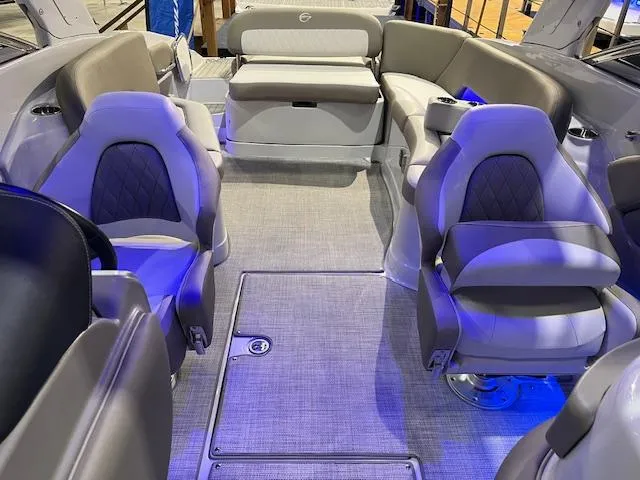 Slide: The Image of 2025 Crownline Eclipse E285 boat interior with plush seating and modern design. - 5