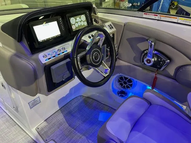 Slide: The Image of 2025 Crownline Eclipse E285 boat cockpit with modern steering and control panel. - 7