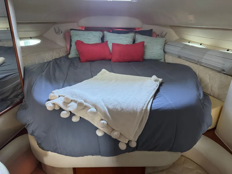 Slide: The Image of Cozy bedroom in 2000 Sea Ray 340 Sundancer yacht with plush bedding and pillows. - 10