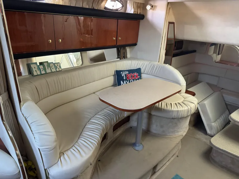 Slide: The Image of Interior of 2000 Sea Ray 340 Sundancer with white seating and table. - 11