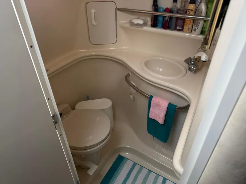Slide: The Image of Compact bathroom in 2000 Sea Ray 340 Sundancer yacht with sink and toilet. - 14