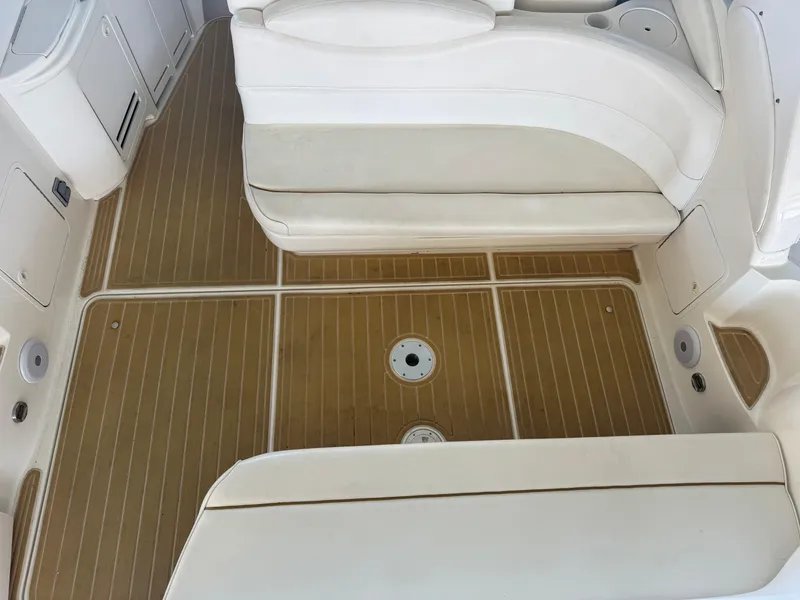 Slide: The Image of Interior view of 2000 Sea Ray 340 Sundancer boat with teak flooring and white seating. - 18