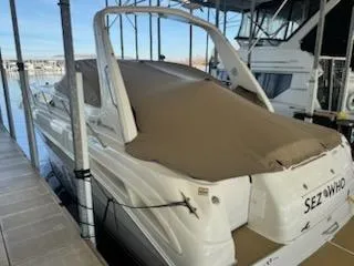 Slide: The Image of 2000 Sea Ray 340 Sundancer docked with brown cover in marina. - 19