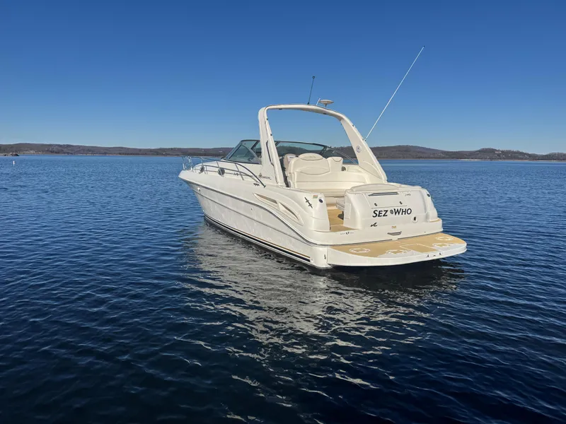 Slide: The Image of 2000 Sea Ray 340 Sundancer boat on calm blue water. - 3