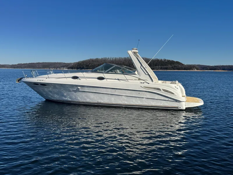 Slide: The Image of 2000 Sea Ray 340 Sundancer yacht on calm water under clear blue sky. - 4