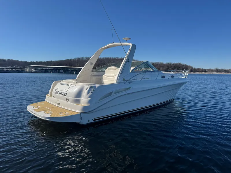 Slide: The Image of 2000 Sea Ray 340 Sundancer boat on calm water under clear blue sky. - 5