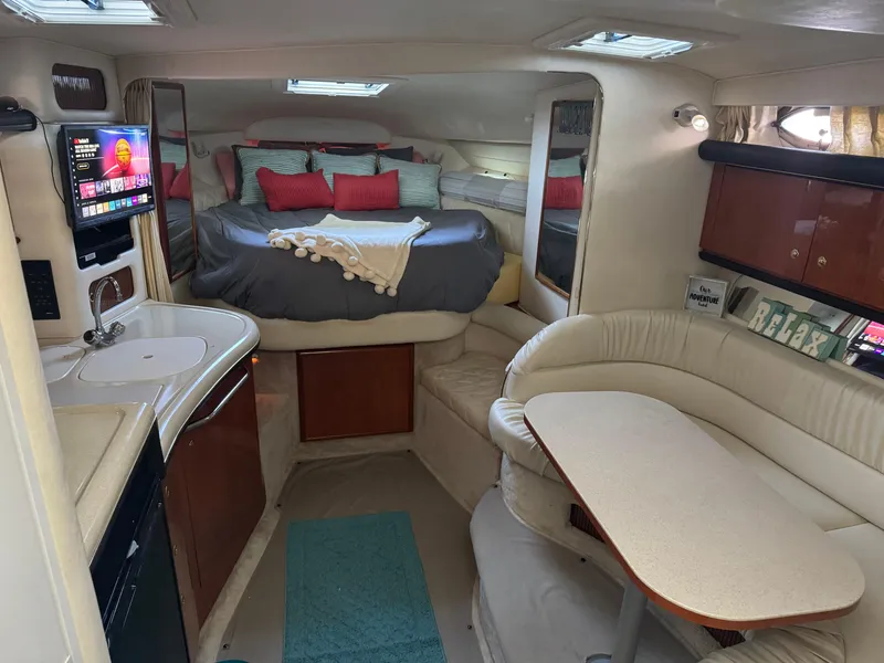 Slide: The Image of Interior of 2000 Sea Ray 340 Sundancer with cozy seating and modern amenities. - 9