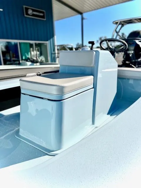 Slide: The Image of 2024 Chittum Skiffs 18 Islamorada boat interior with cushioned seat and steering console. - 7