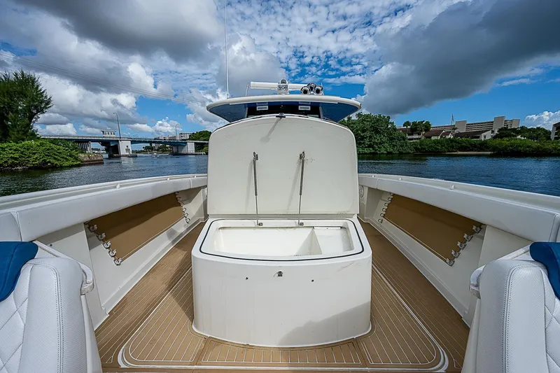Slide: The Image of HCB 53 Sueños 2016 boat interior with open storage, scenic waterway view. - 14