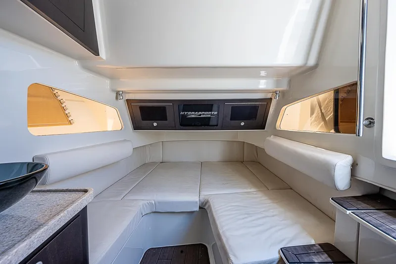 Slide: The Image of Interior of 2016 HCB 53 Sueños boat with cushioned seating and modern design. - 18