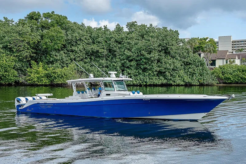 Slide: The Image of 2016 HCB 53 Sueños boat on calm water, surrounded by lush greenery. - 3