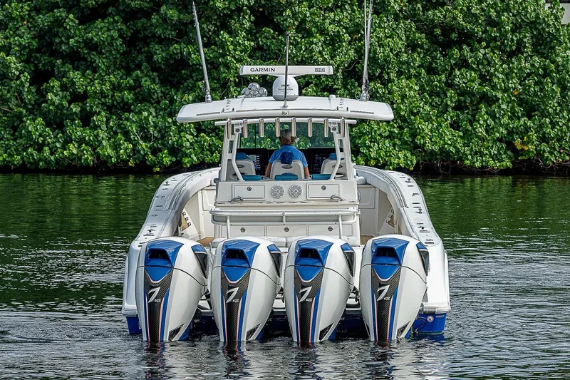 Slide: The Image of 2016 HCB 53 Sueños boat with five powerful outboard engines on a calm waterway. - 7