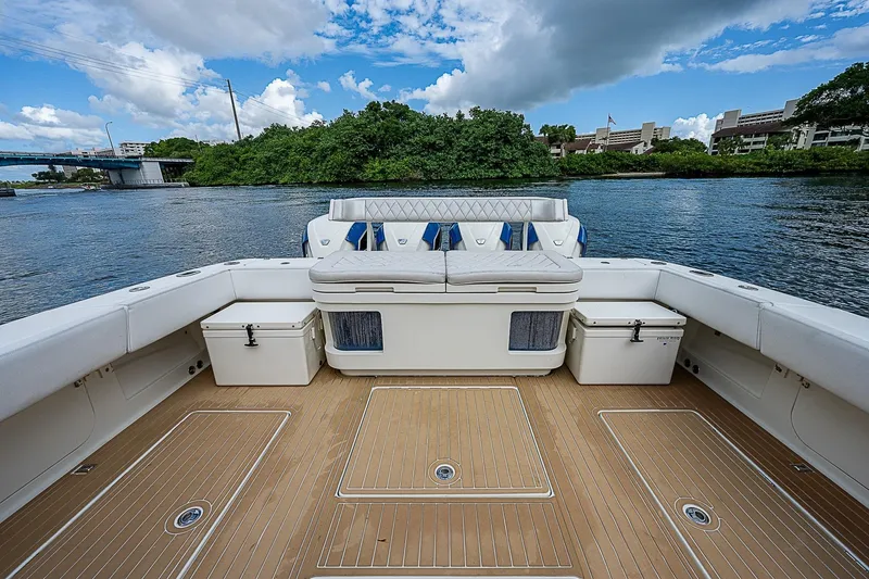 Slide: The Image of 2016 HCB 53 Sueños boat deck with seating, surrounded by water and lush greenery. - 9