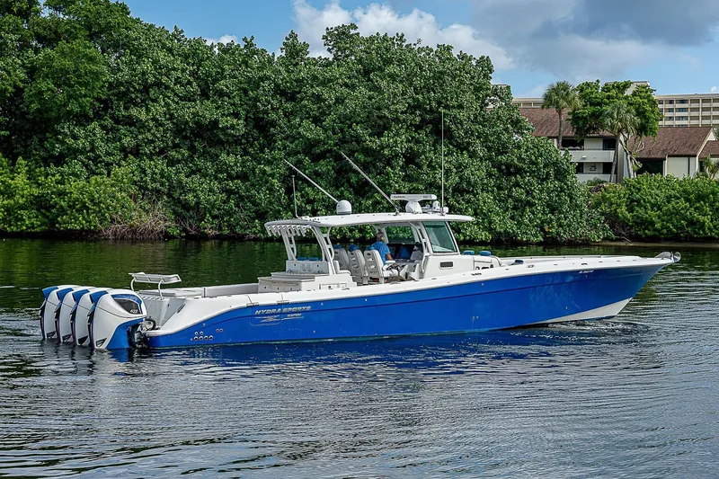 The Image of 2016 HCB 53 Sueños boat with blue hull, cruising on a calm waterway. - 0