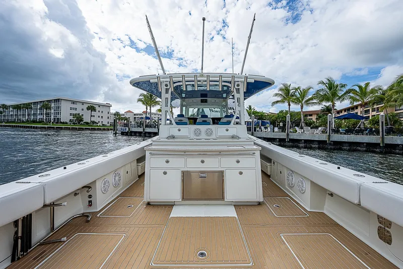 Slide: The Image of 2016 HCB 53 Sueños boat docked, featuring spacious deck and modern design. - 10