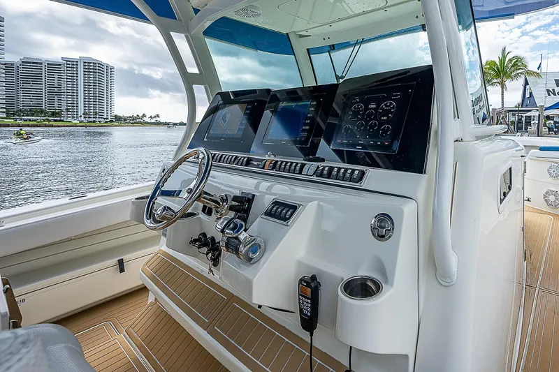Slide: The Image of Helm of 2016 HCB 53 Sueños boat with modern controls and waterfront view. - 13