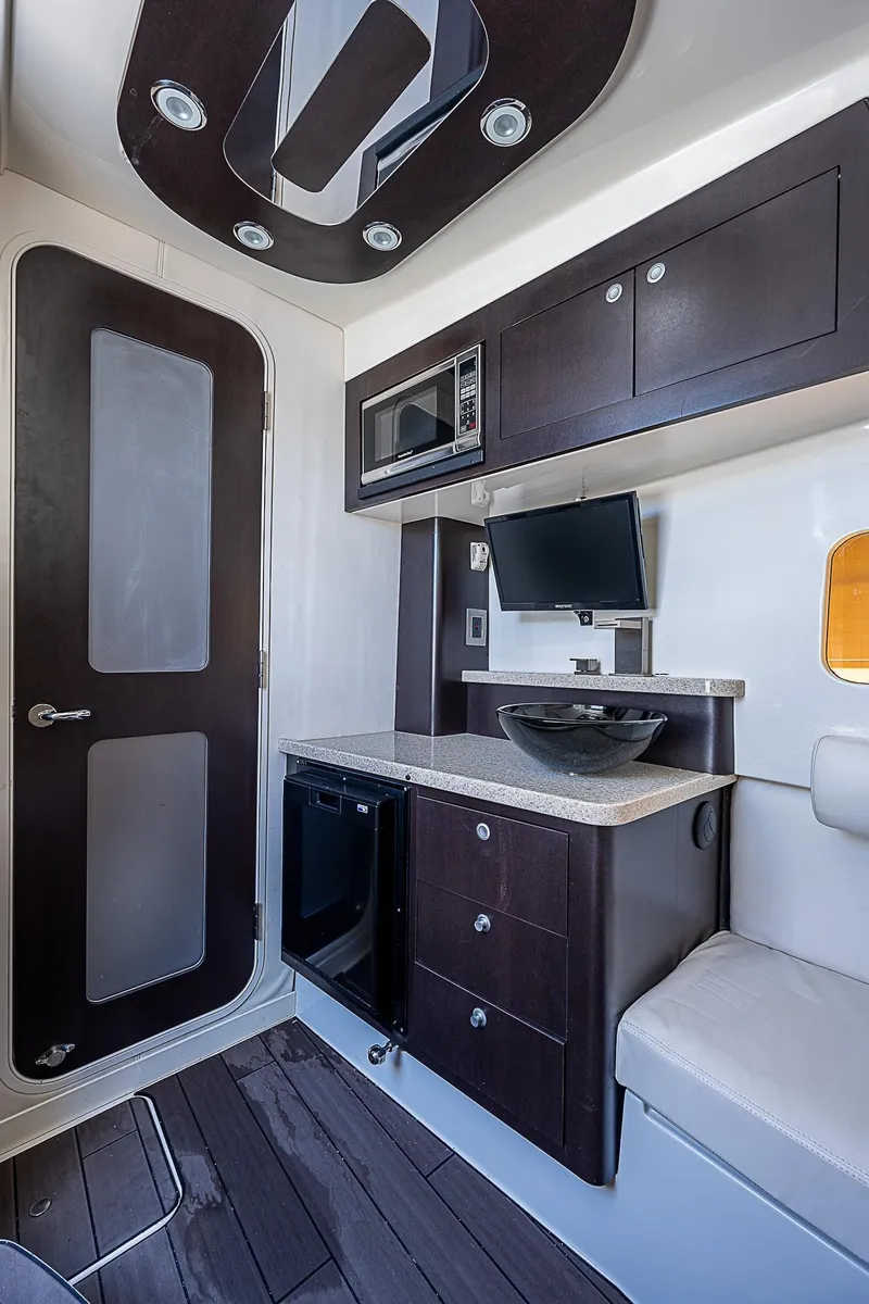 Slide: The Image of Interior of 2016 HCB 53 Sueños boat with modern kitchenette and seating area. - 17