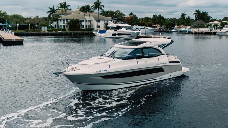 Slide: The Image of 2019 Jeanneau Leader 33 yacht cruising in a serene marina setting. - 0