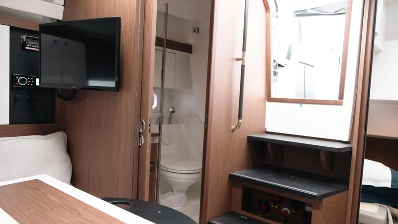 Slide: The Image of Interior of 2019 Jeanneau Leader 33 yacht, featuring a cozy cabin with modern amenities. - 13