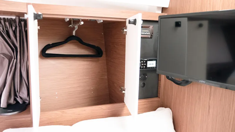 Slide: The Image of Interior of 2019 Jeanneau Leader 33 showing closet, TV, and control panel. - 14