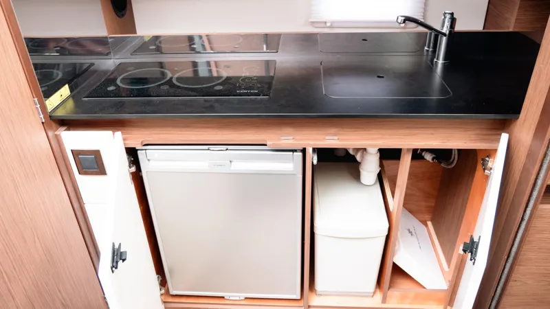 Slide: The Image of 2019 Jeanneau Leader 33 kitchen with stove, sink, and storage cabinets. - 18