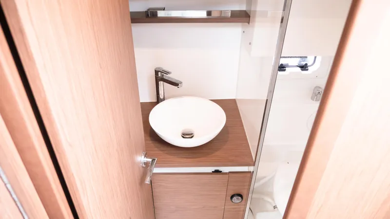 Slide: The Image of 2019 Jeanneau Leader 33 bathroom with modern sink and wooden cabinetry. - 19
