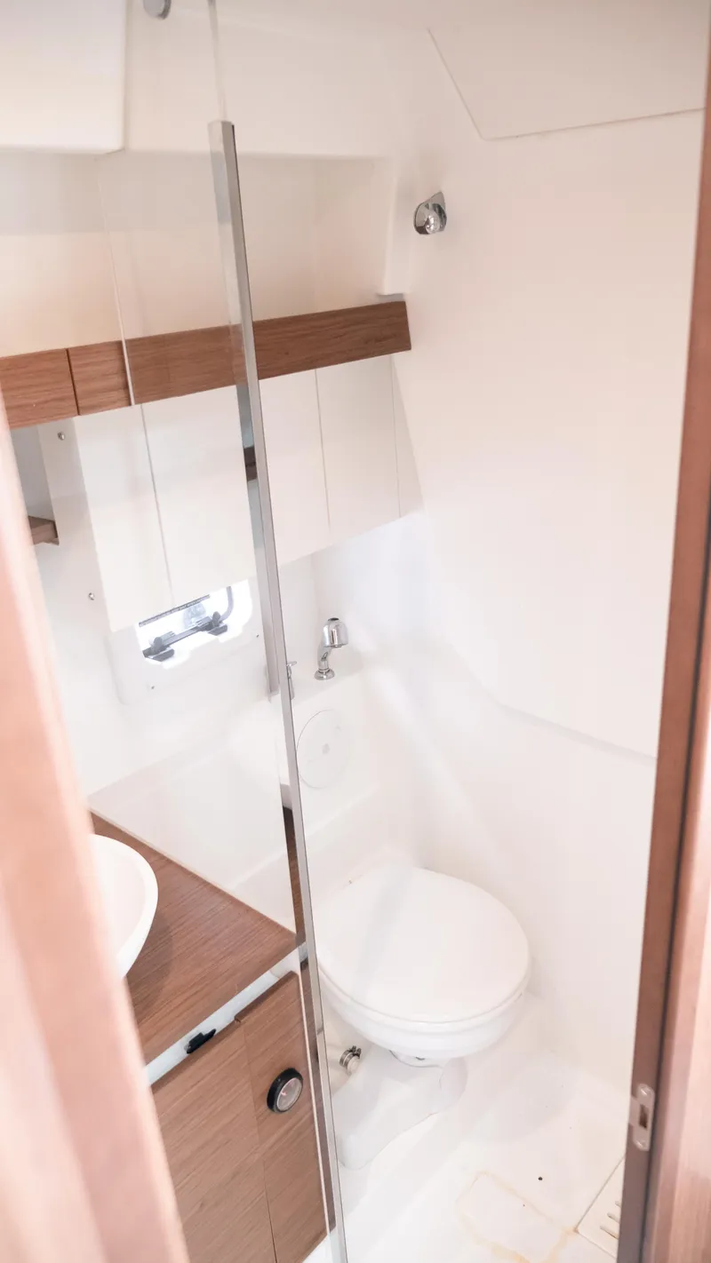 Slide: The Image of Bathroom interior of 2019 Jeanneau Leader 33 yacht, featuring modern fixtures and wood accents. - 20