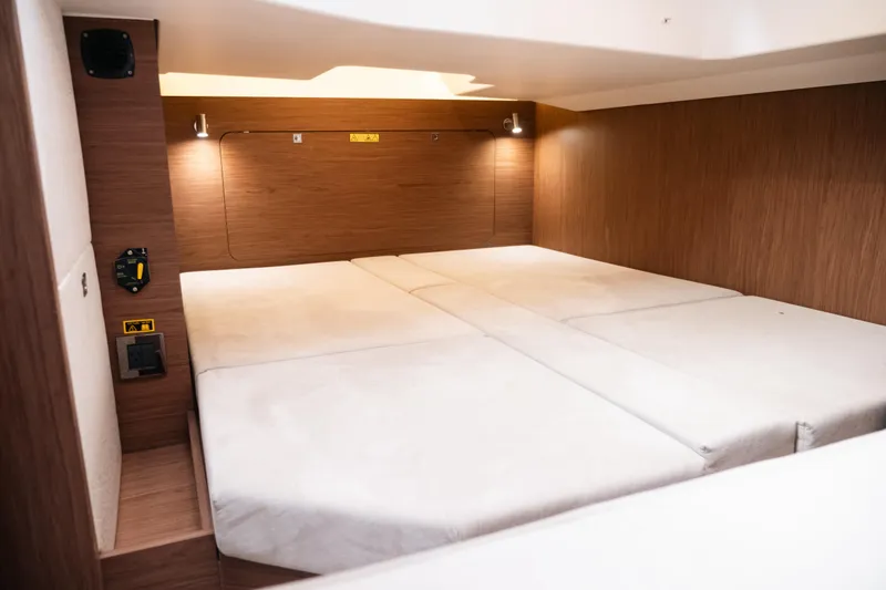 Slide: The Image of 2019 Jeanneau Leader 33 cabin interior with cozy bed and wooden finish. - 22