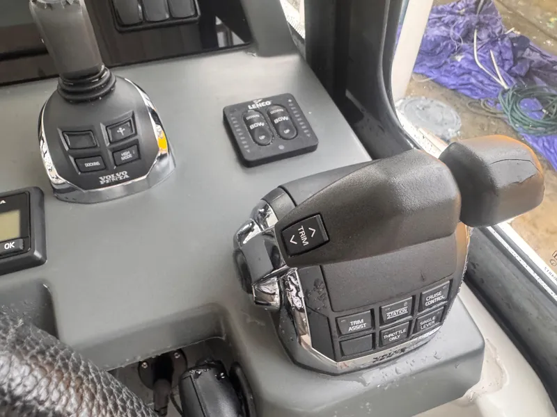 Slide: The Image of Control panel of a 2019 Jeanneau Leader 33 boat, featuring joystick and throttle controls. - 25