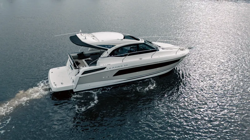 Slide: The Image of 2019 Jeanneau Leader 33 cruising on calm water, showcasing sleek design and elegance. - 8