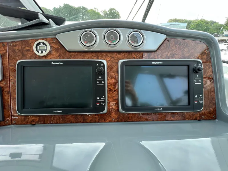 Slide: The Image of Dashboard of 2014 Formula 45 Yacht with dual Raymarine displays and wood paneling. - 10