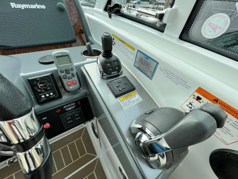 Slide: The Image of Control panel of a 2014 Formula 45 Yacht with navigation equipment and throttle. - 12