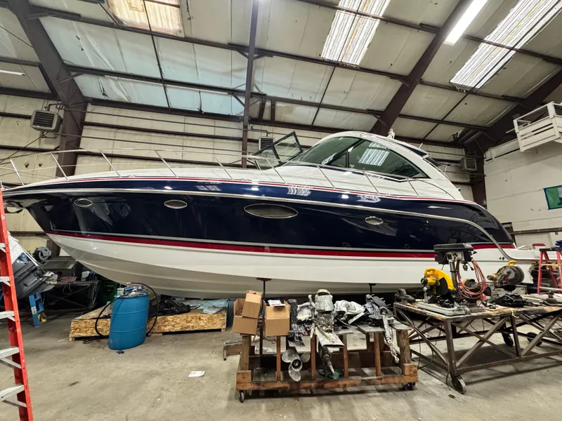 Slide: The Image of 2014 Formula 45 Yacht in a workshop setting, surrounded by tools and equipment. - 2